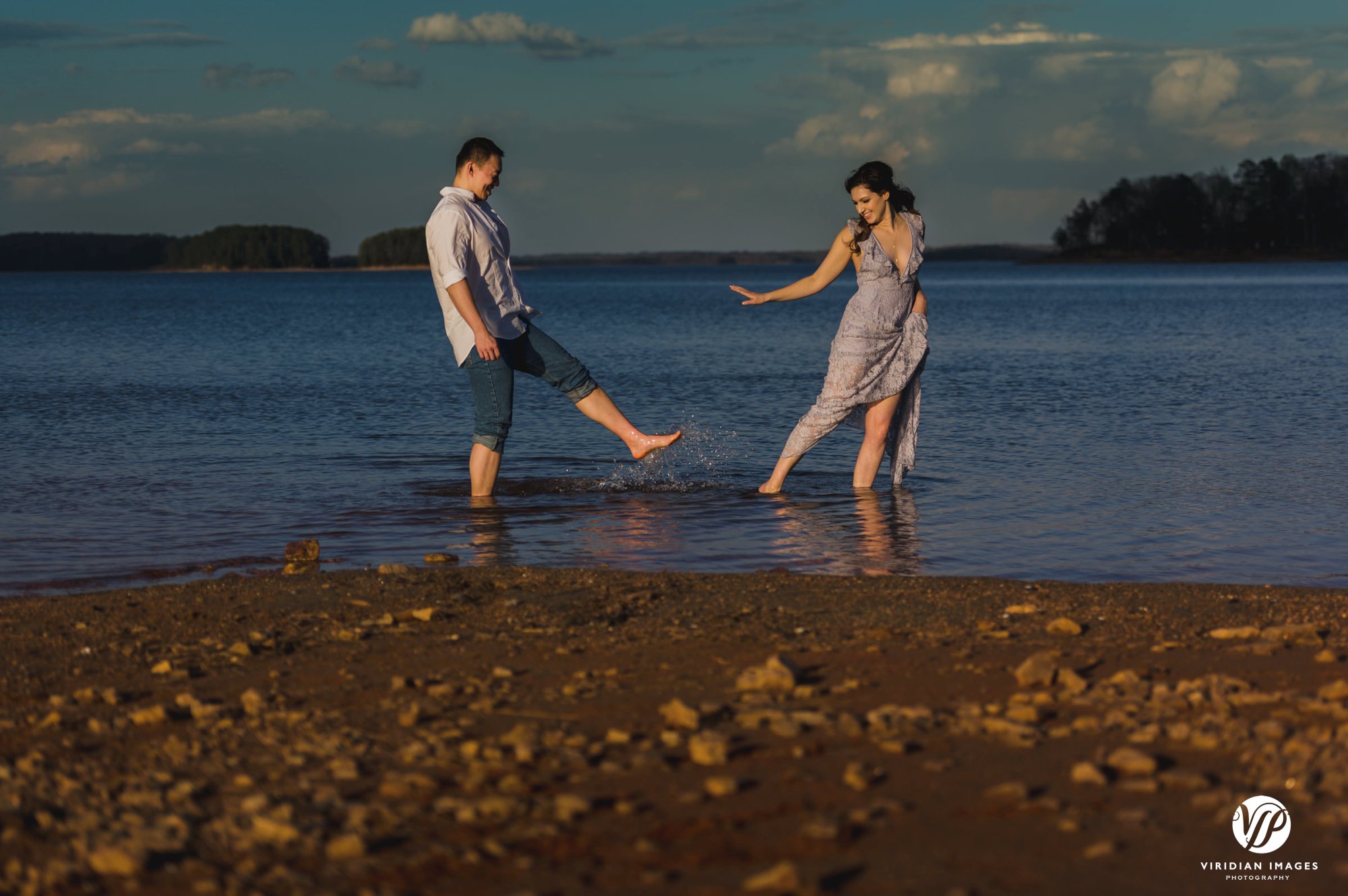 playful couple on water edge