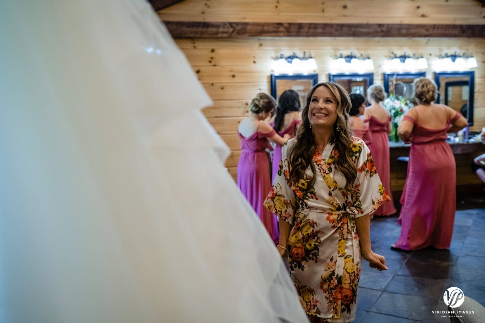 happy bride to be admiring dress hanging