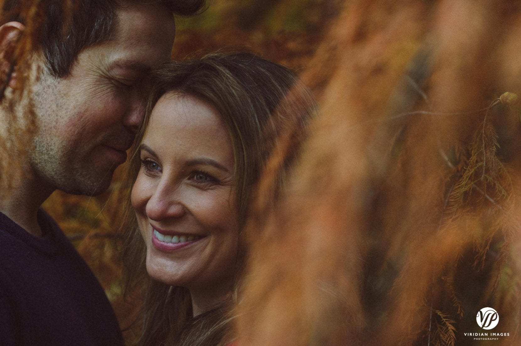 creative portrait through fall leaves at piedmont park