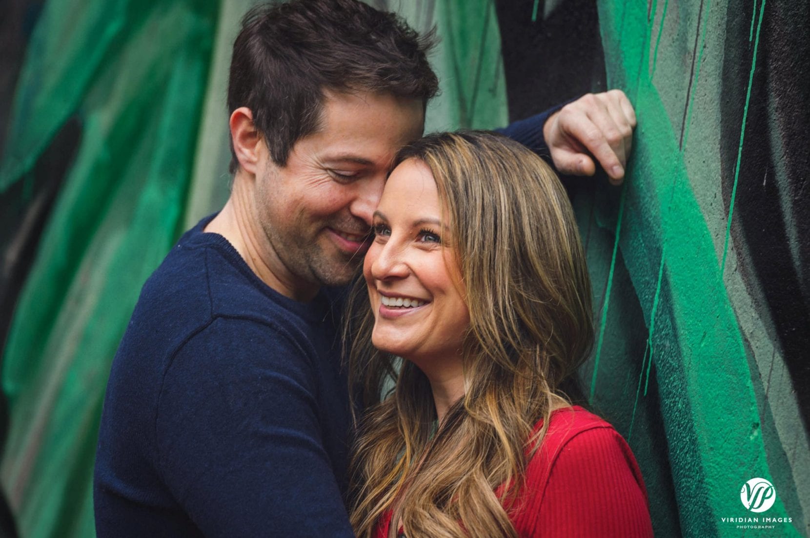 couple smiling front of mural at piedmont park