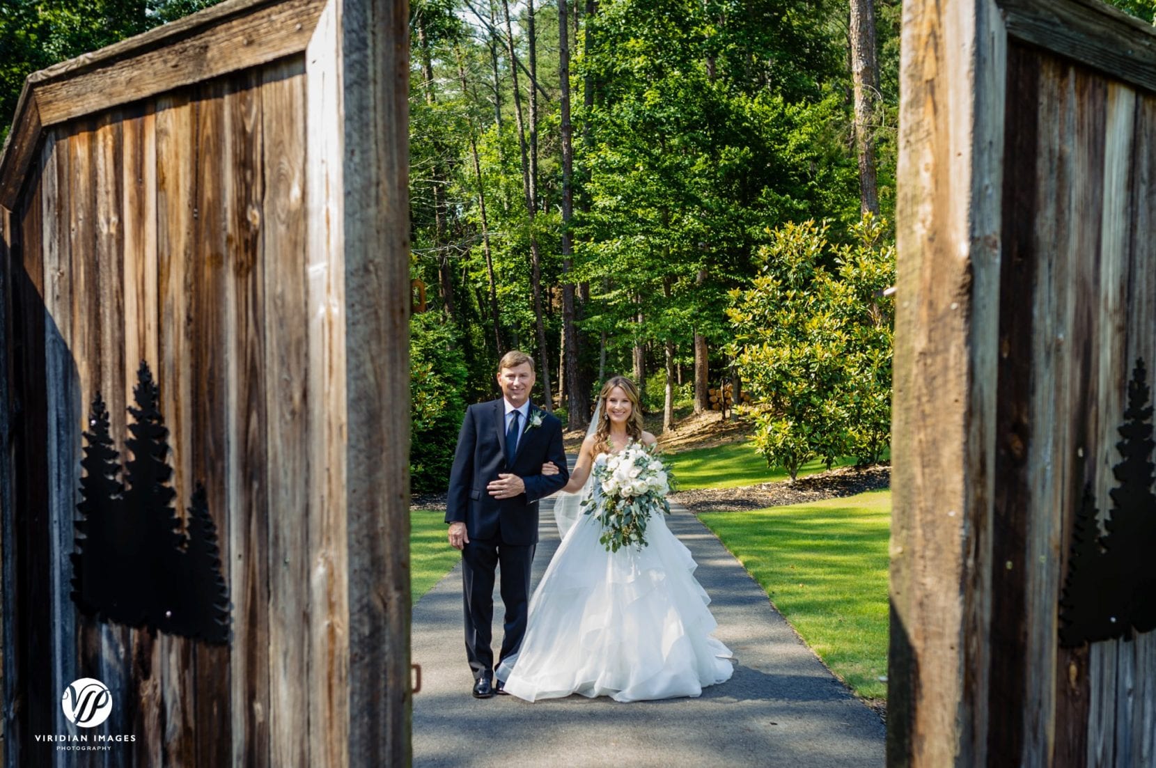 father and bride open barn doors