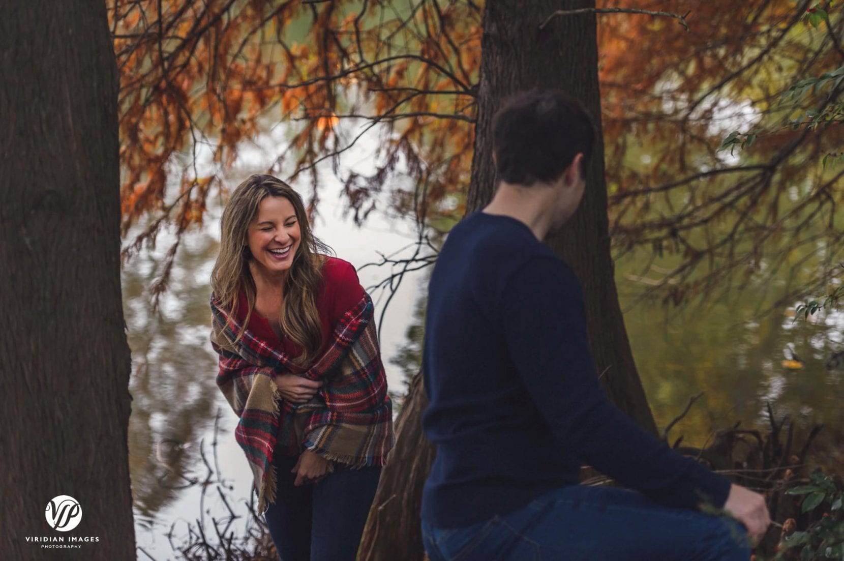 couple laughing during engagement photo session at piedmont park