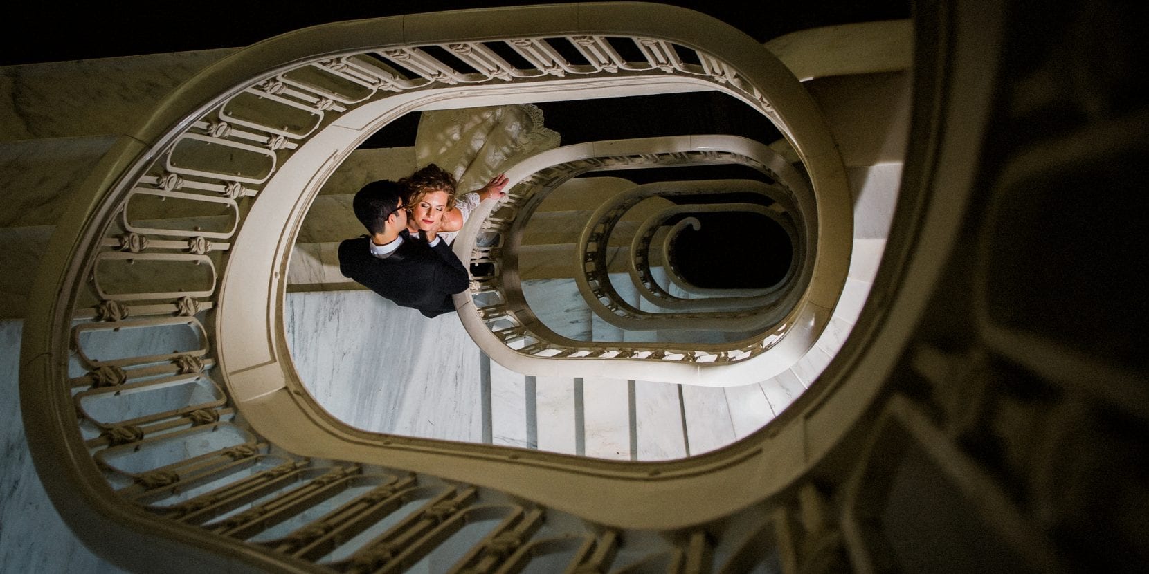 bride and groom romantic on circular staircase at the georgian terrace atlanta