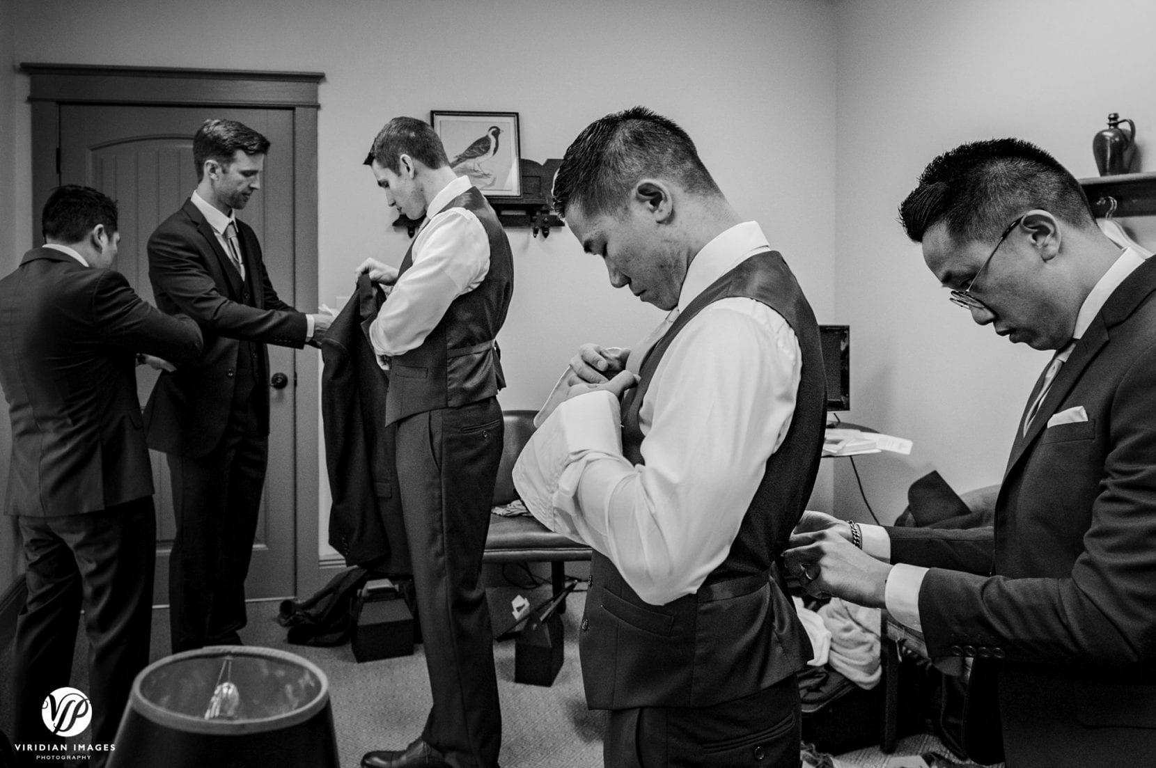 groom with groomsmen getting ready