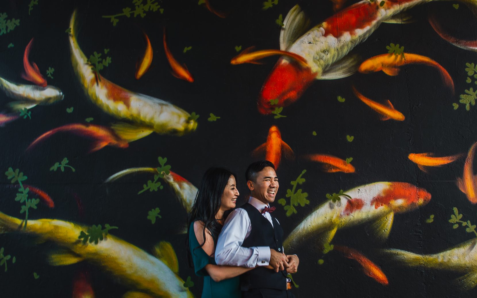 couple tickling front of koi mural along atlanta beltline