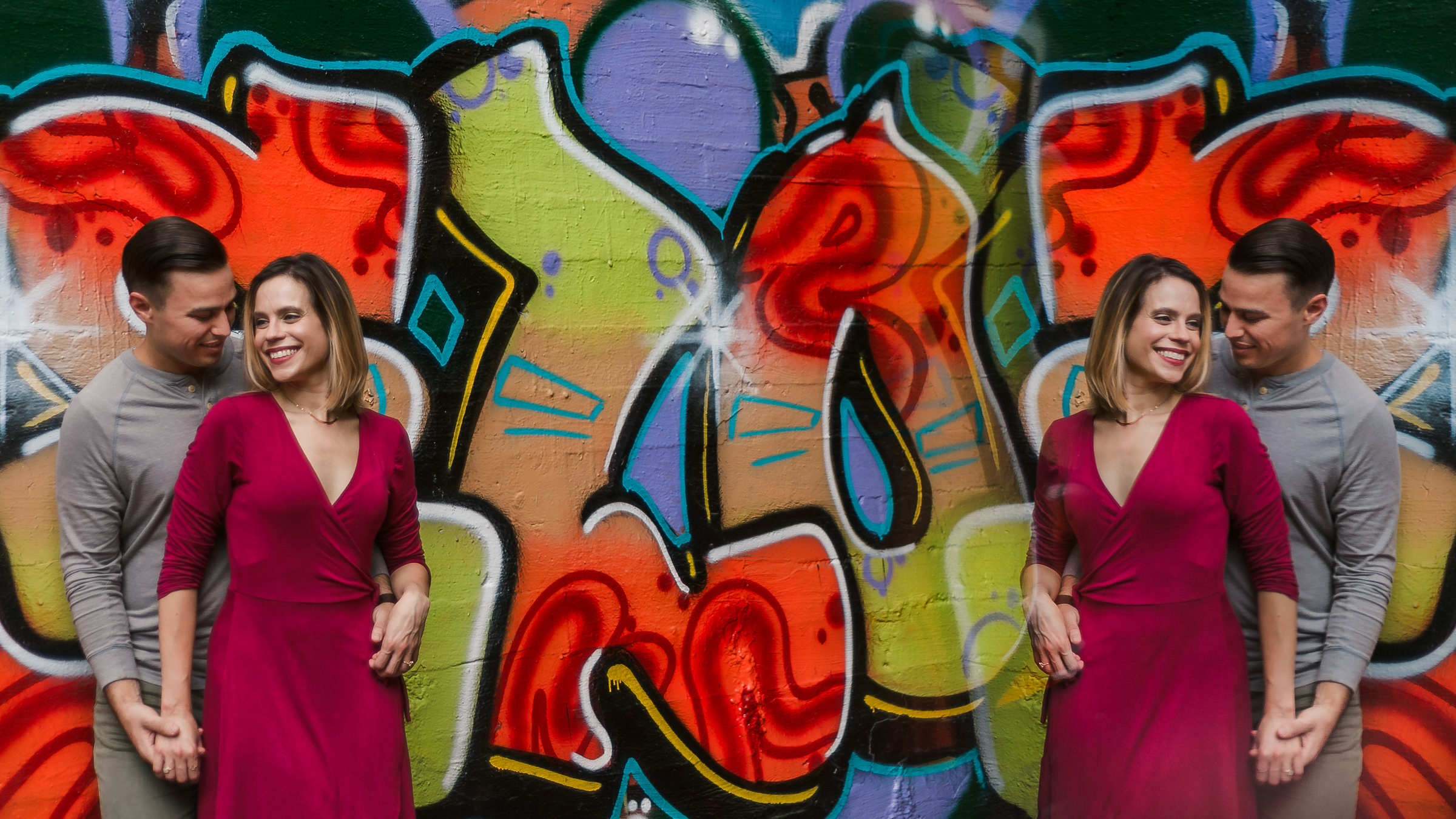 photo shoot couple engagement against graffiti wall reflection