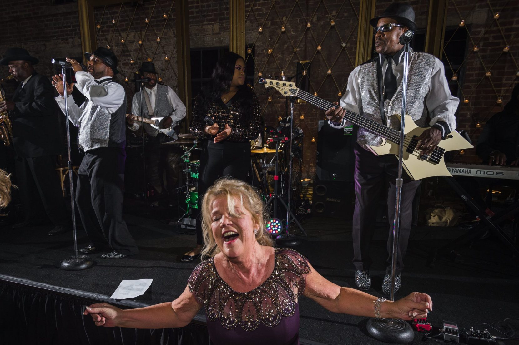 mother bride letting loose with band during wedding reception at bishop station atlanta