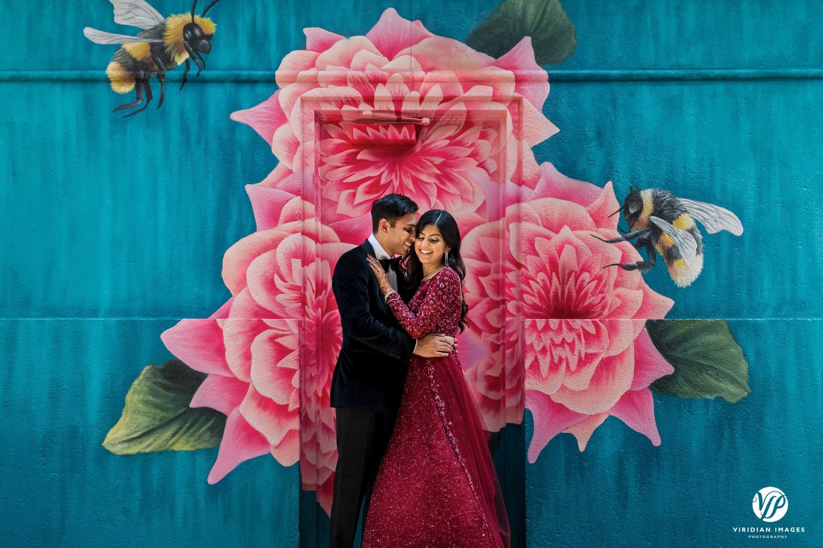 bride and groom face each other front flower mural