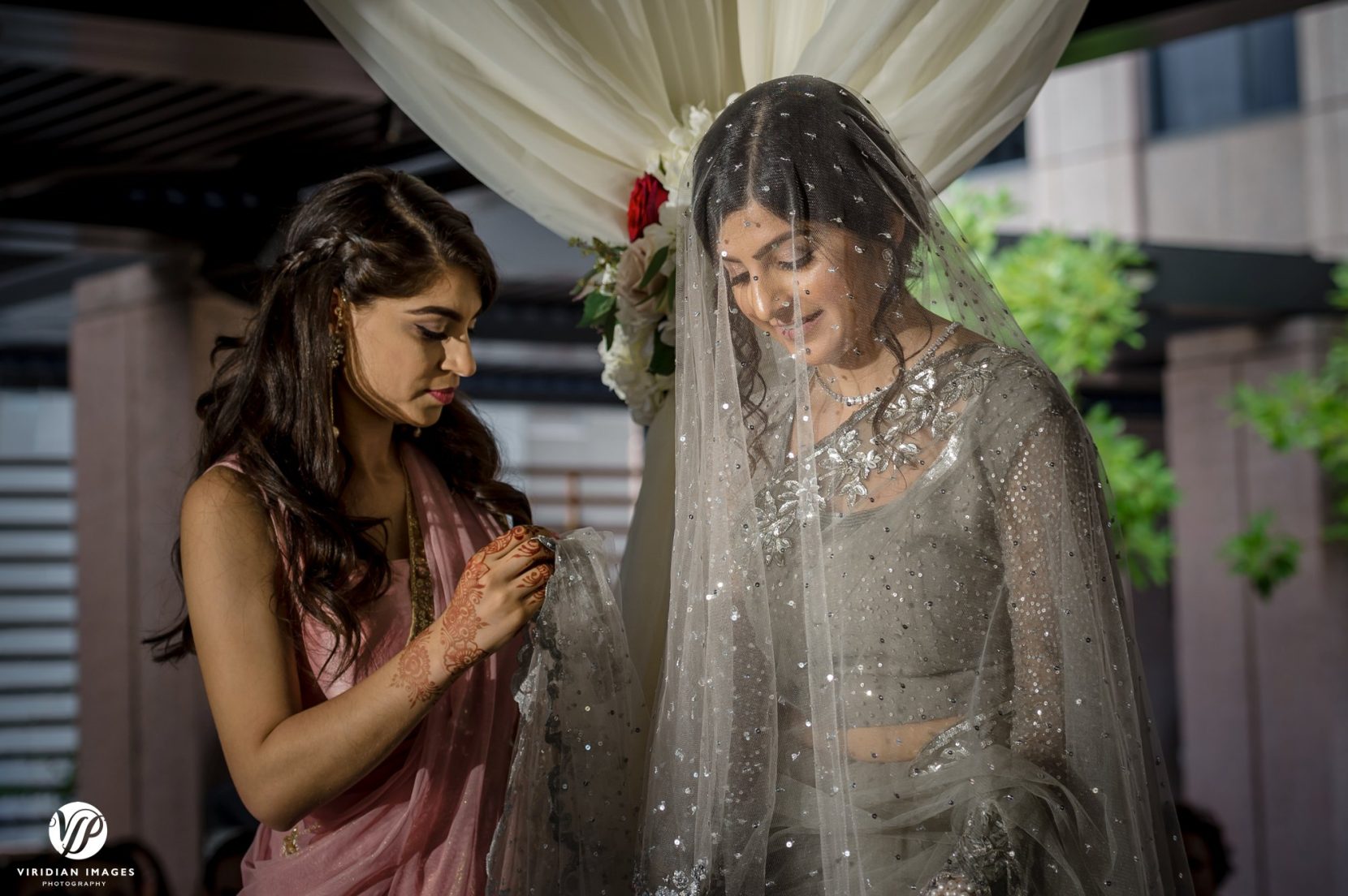 maid of honor helps bride ceremony