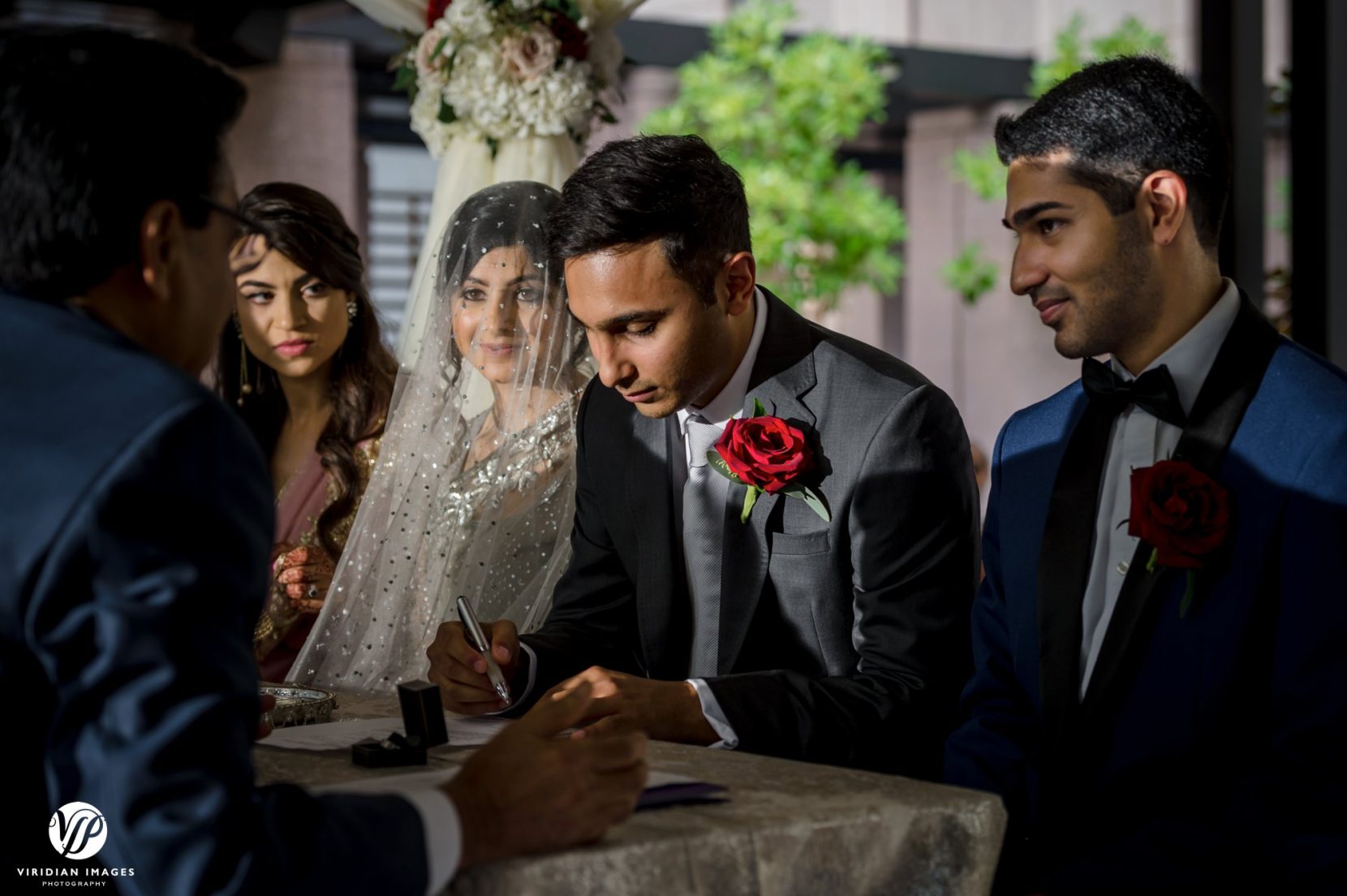 southeast asian ceremony groom signing licence