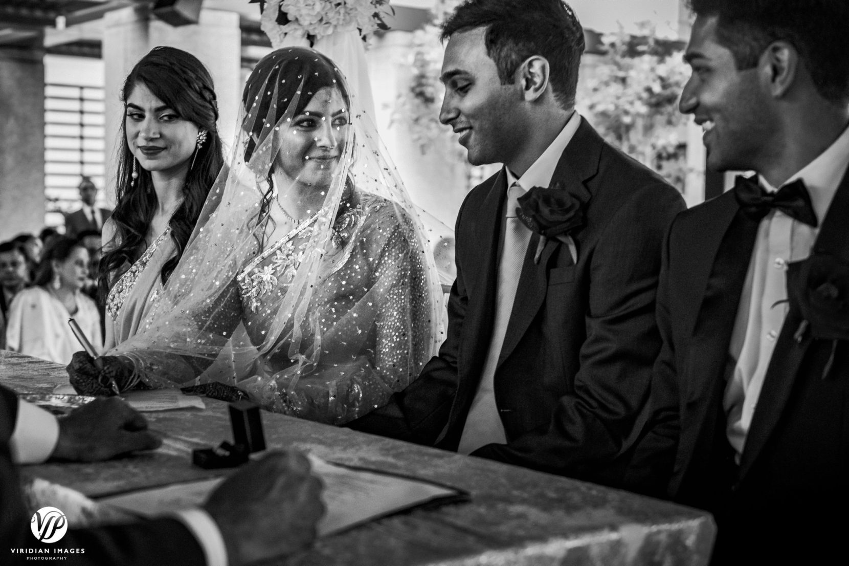 bride looks at groom during ceremony signing