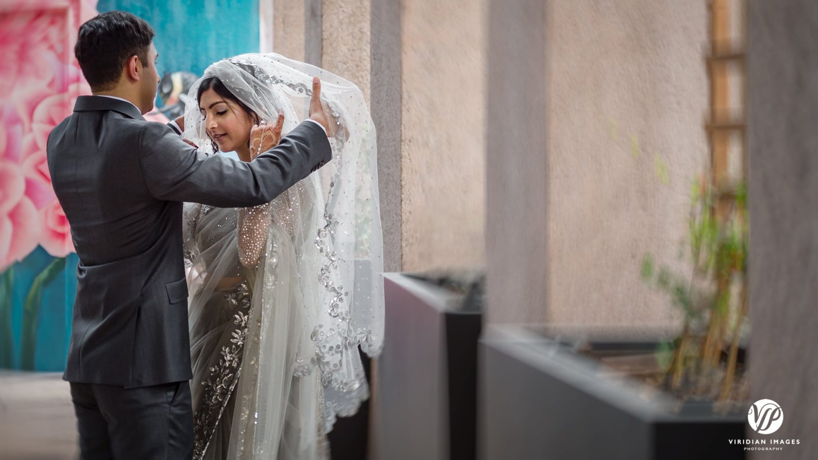 groom lifts veil and kisses bride after ceremony
