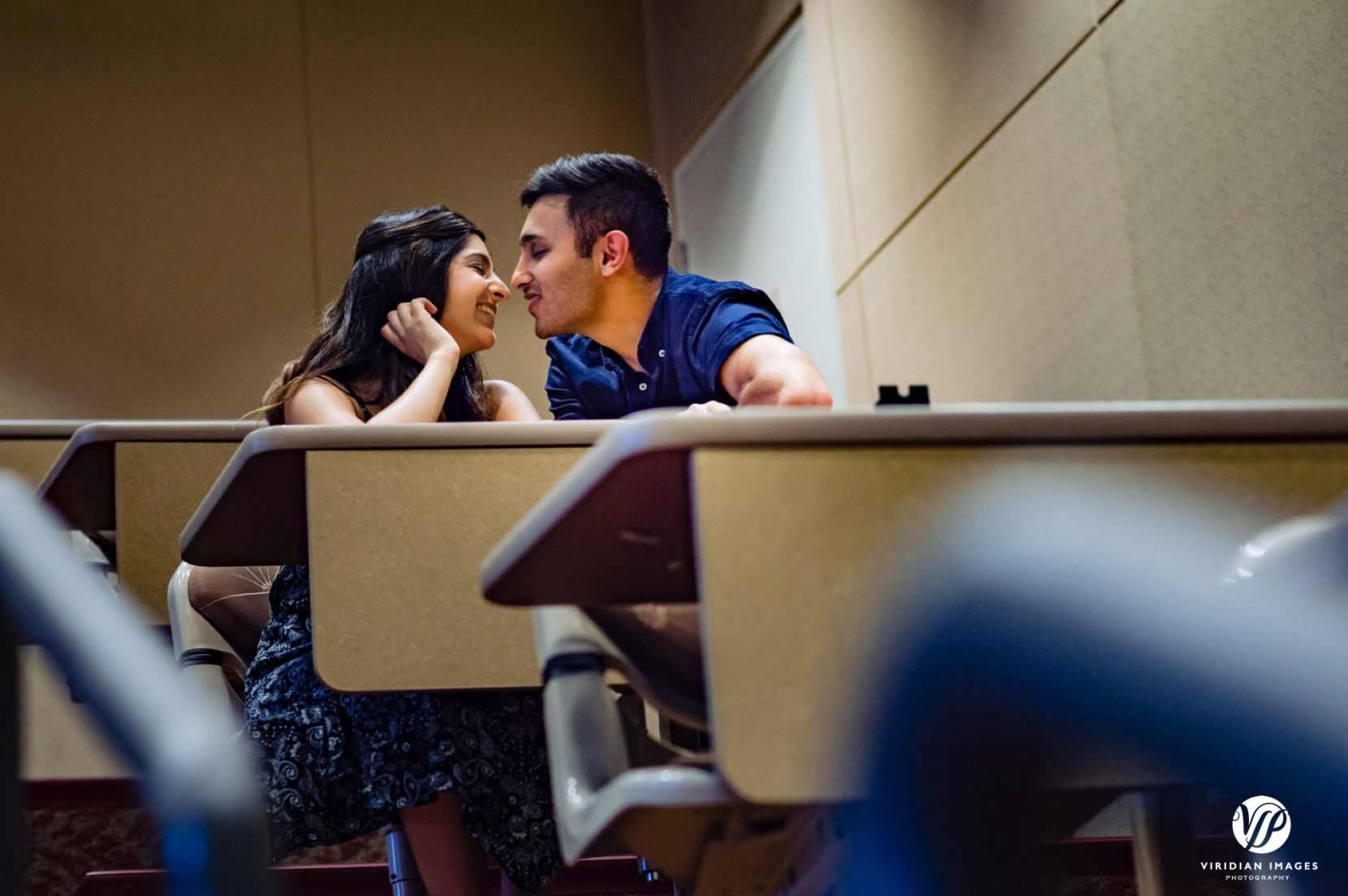 couple about to kiss in classroom auditorium