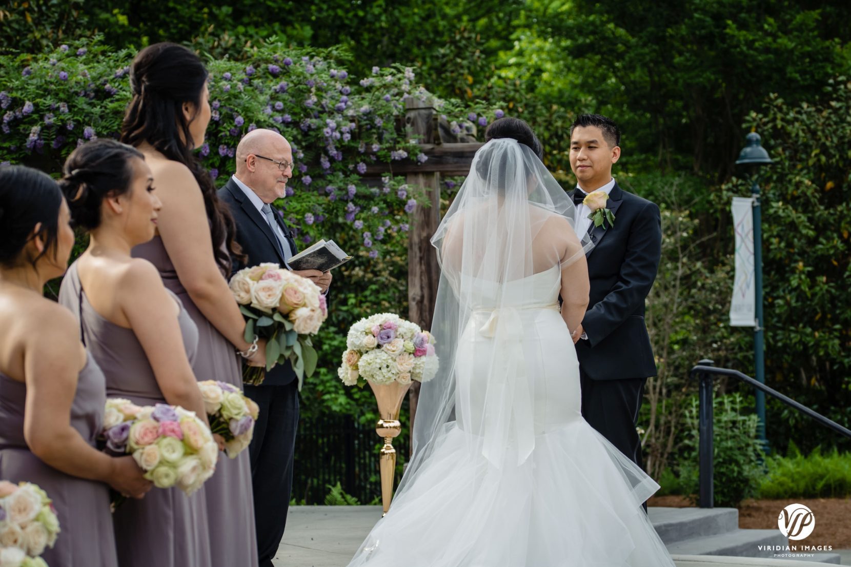 bride and groom with bridesmaids during ceremony