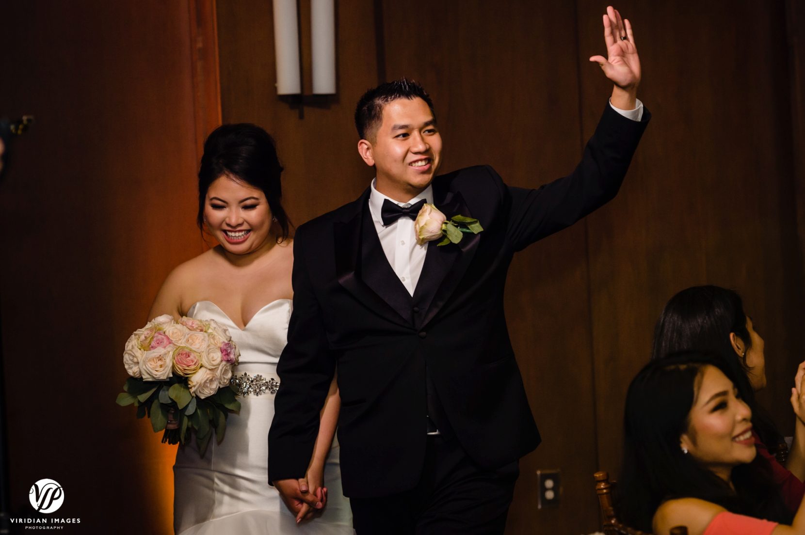 groom comes in with arms up during reception entrance