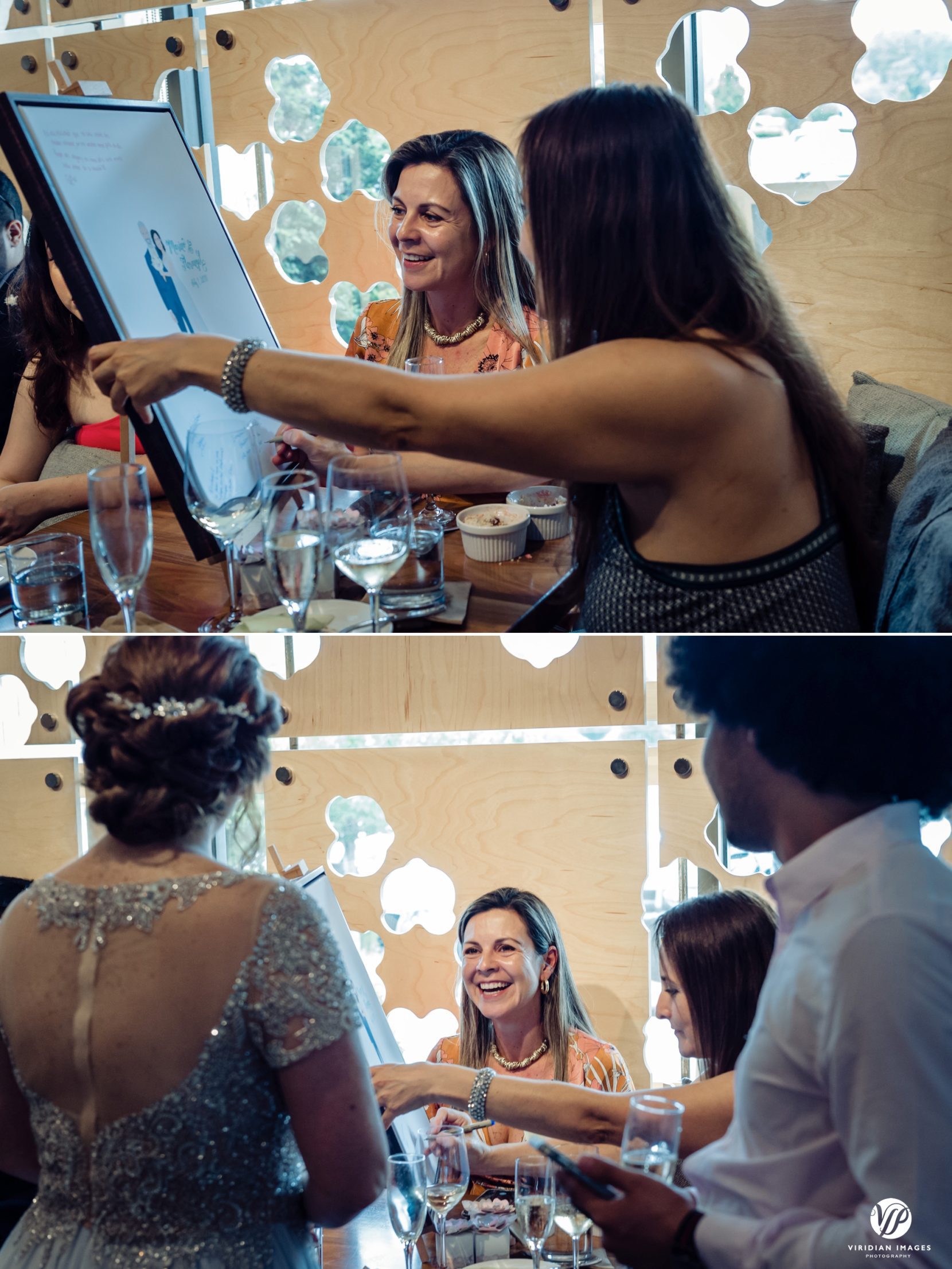 guests signing framed painting of bride and groom