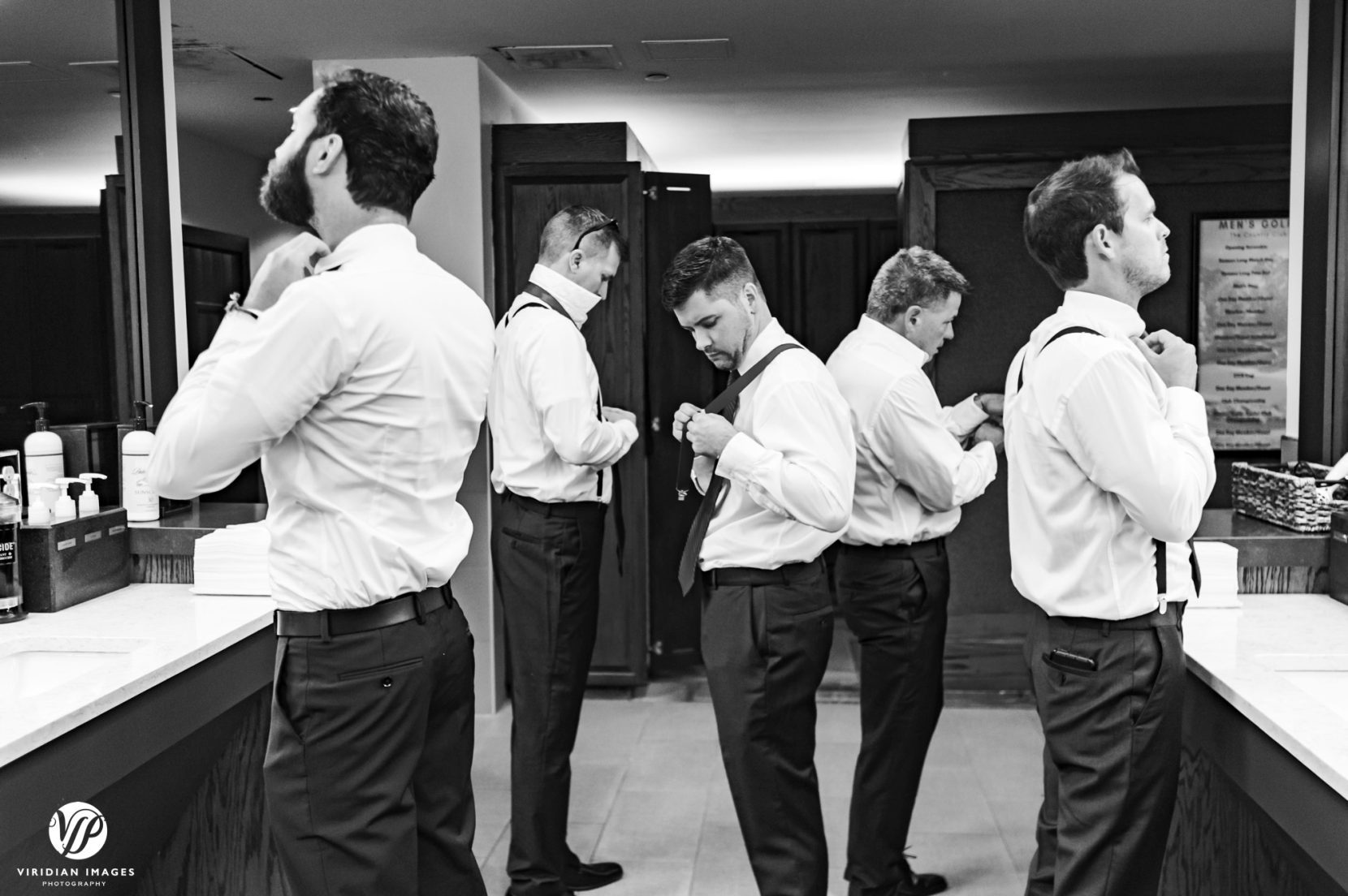 groom and groomsmen getting ready in locker room