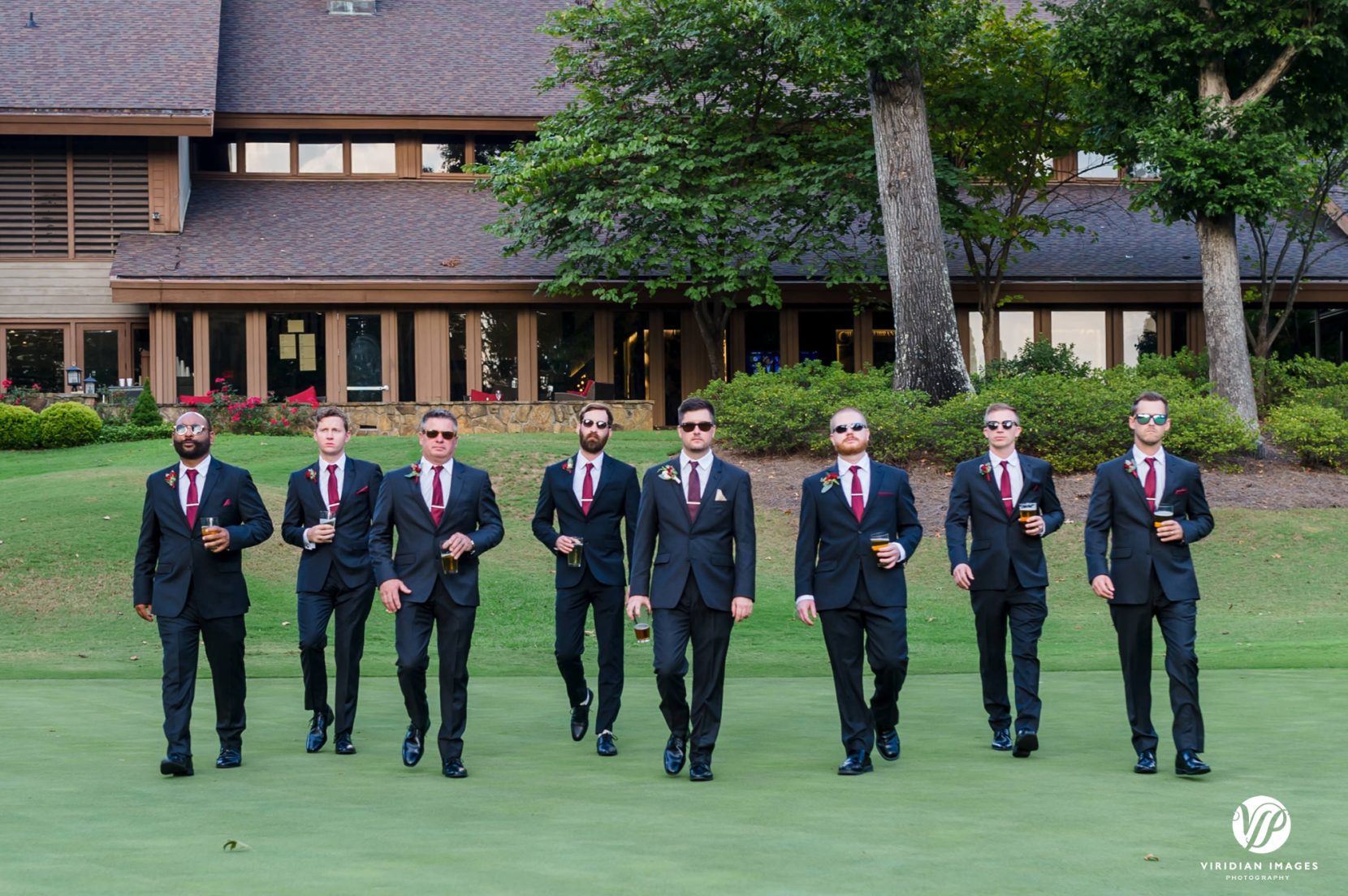 groom and groomsmen walking on golf course
