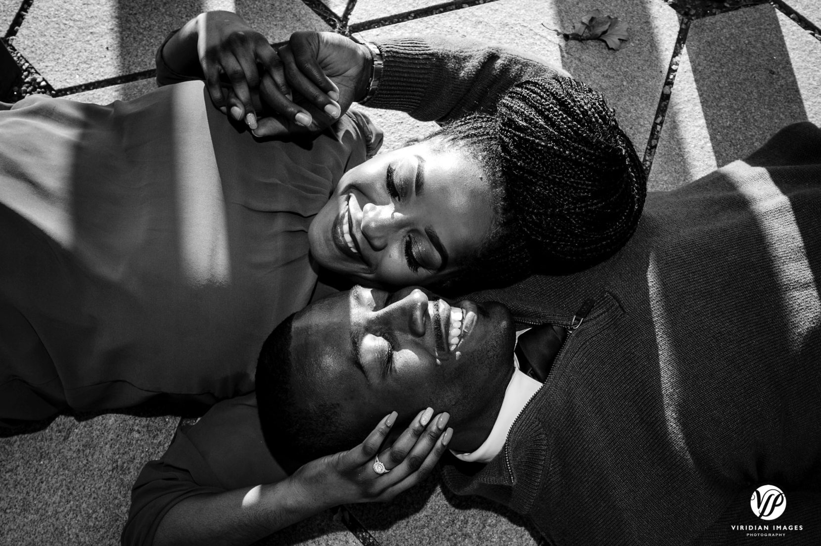 Couple on ground faces near each other enjoying their Atlanta Beltline engagement session