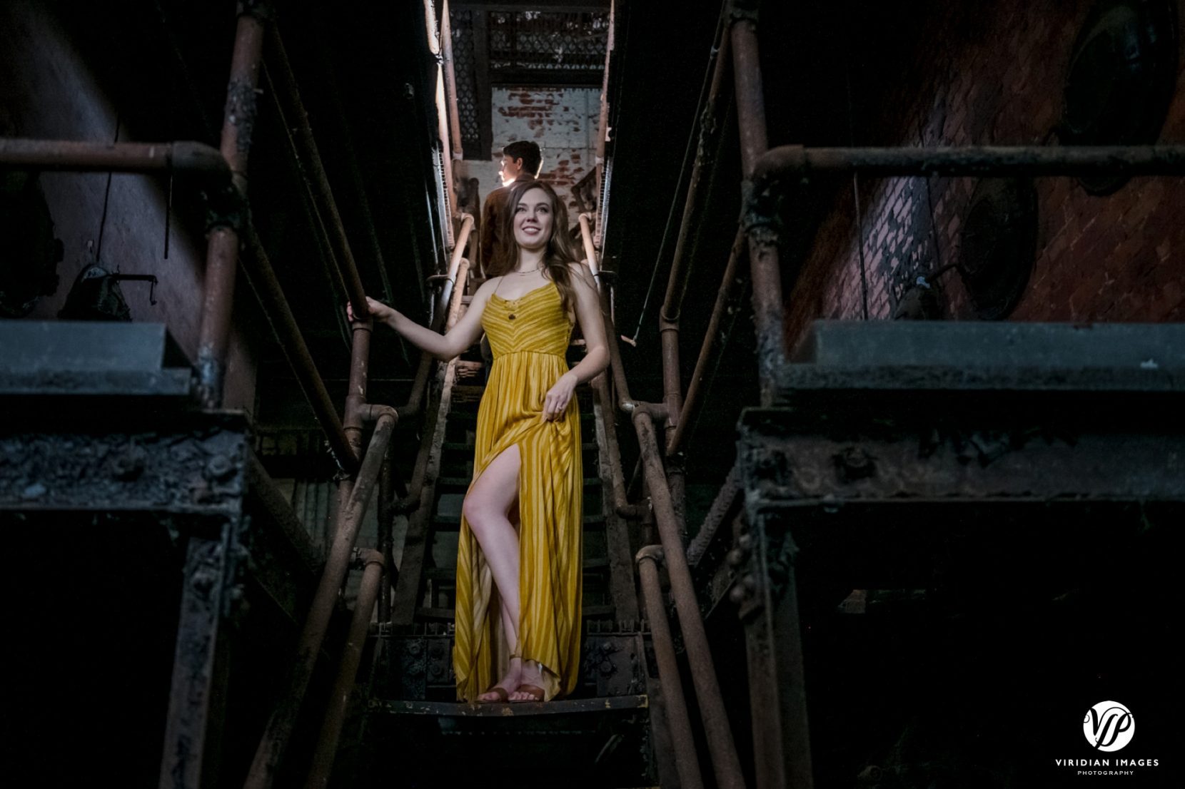 artistic, editorial-styled image of couple on rusty staircase