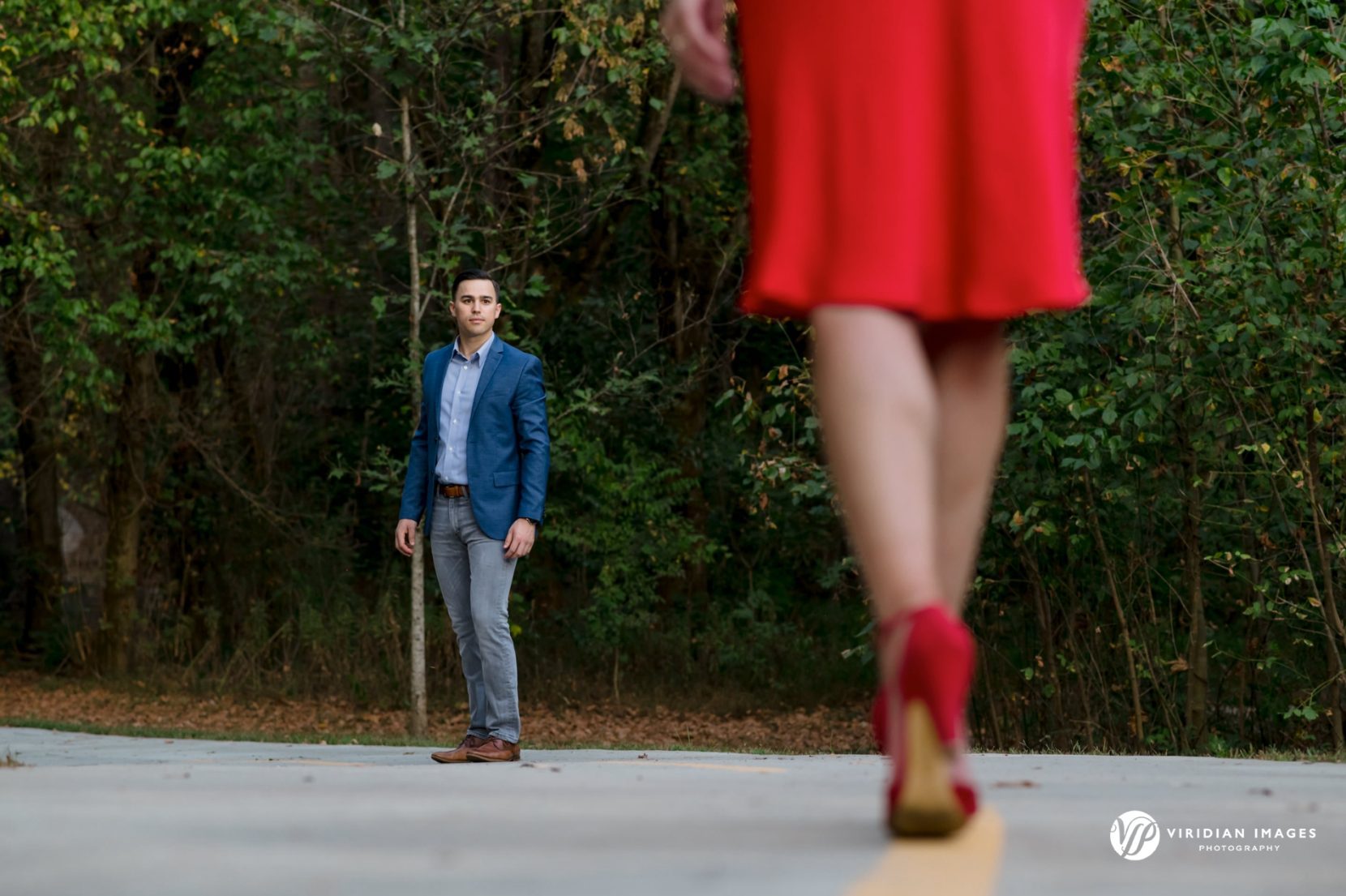 man looking at woman walking towards him red dress and red heels 