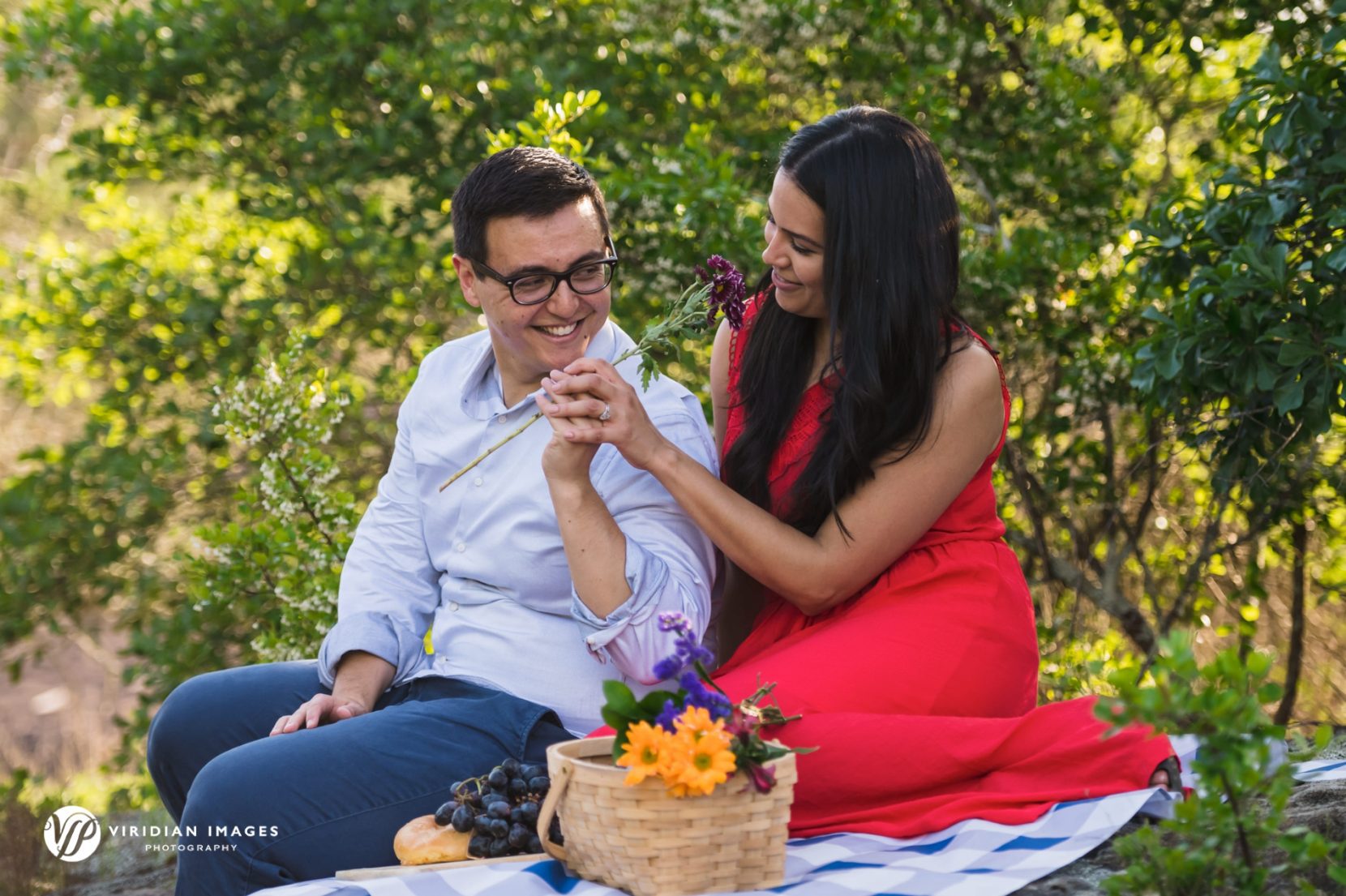 couple sharing purple flower while on picnic on arabia mountain