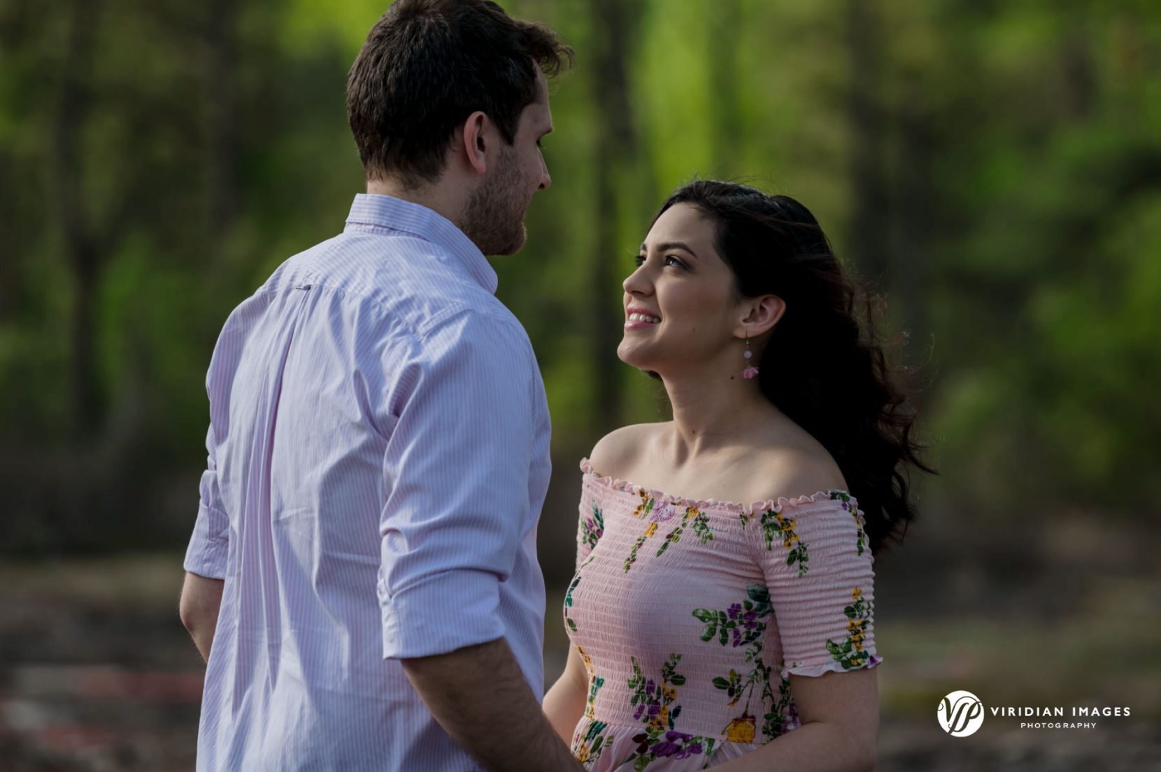 Couple facing each other during engagement session at Arabia Mountain