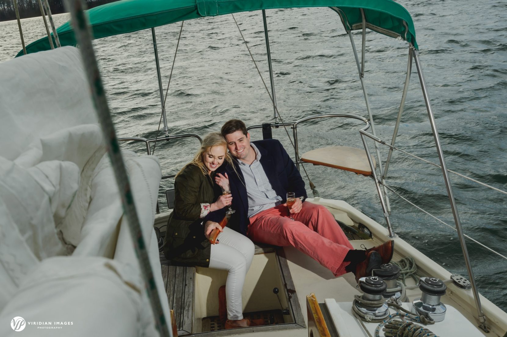 Birds-eye view of couple snuggling while sailing during engagement session