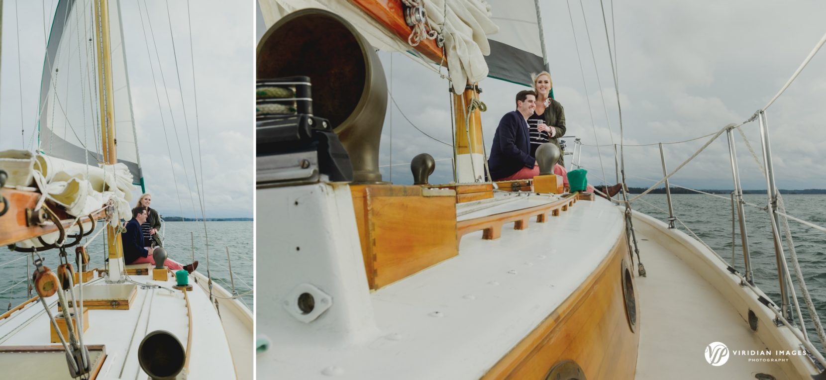 Wide shot of couple drinking champagne while on sailboat during winter engagement session on lake