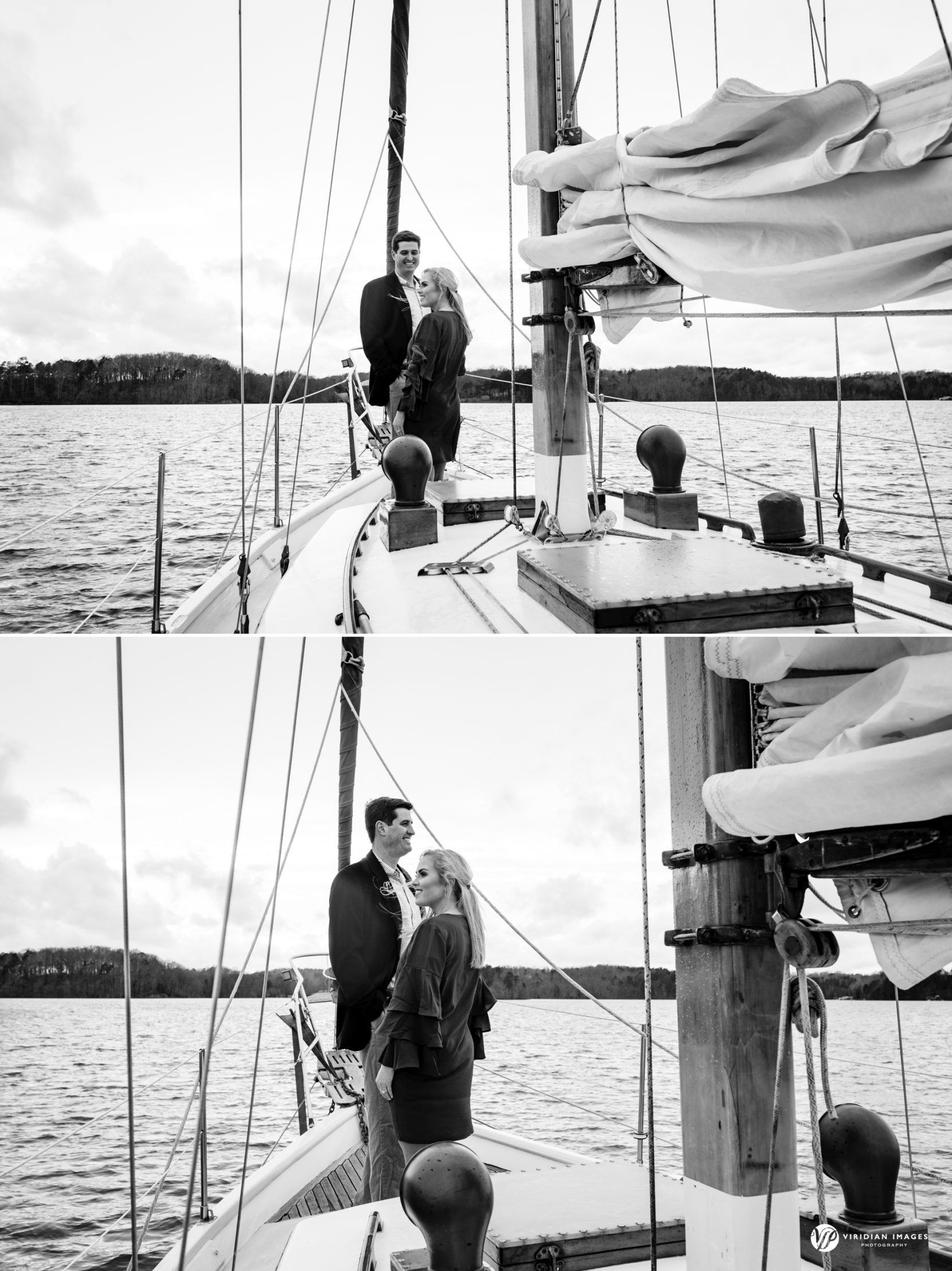 Wide shot of couple on deck of sailboat during winter engagement session on lake