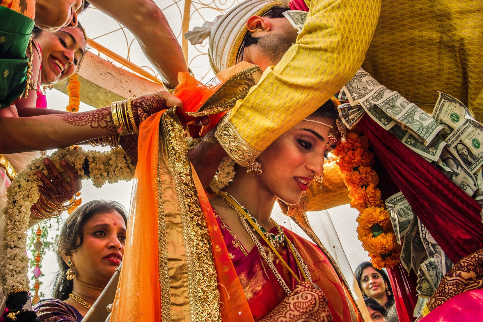southeast asian wedding tradition of groom gifting bride with emerald necklace. groom with lei of dollar bills