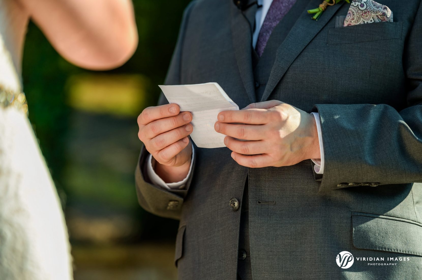 Groom reading vows from piece of paper during wedding ceremony at Yonah Mountain