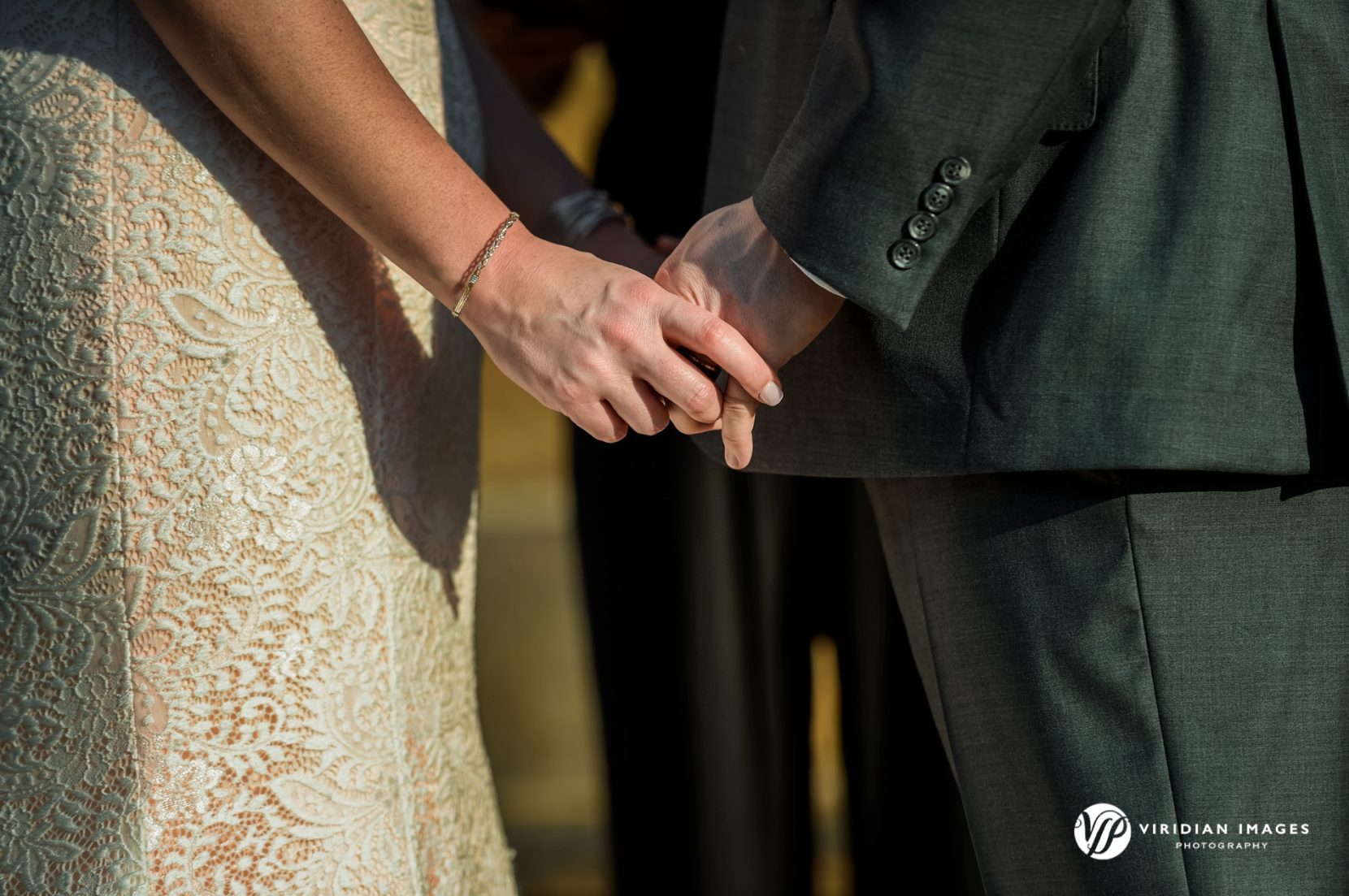 Bride and Groom holding hands during ceremony at Yonah Mountain