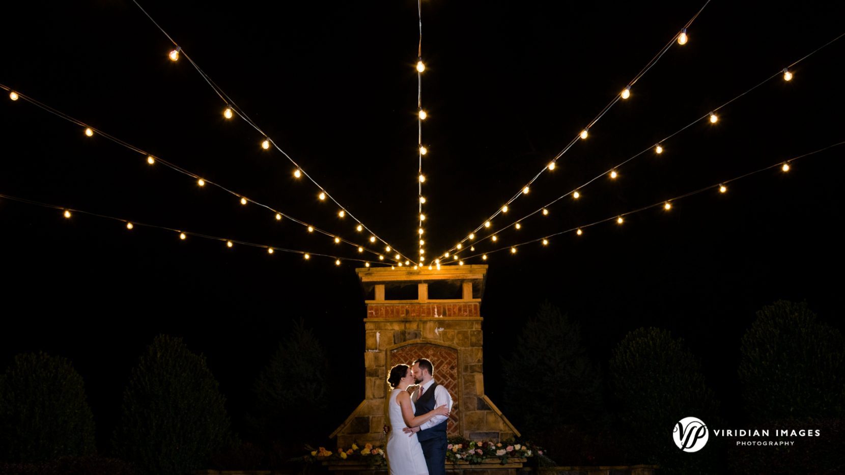 Bride and Groom kissing at the end of their wedding day at Yonah Mountain in Cleveland Georgia