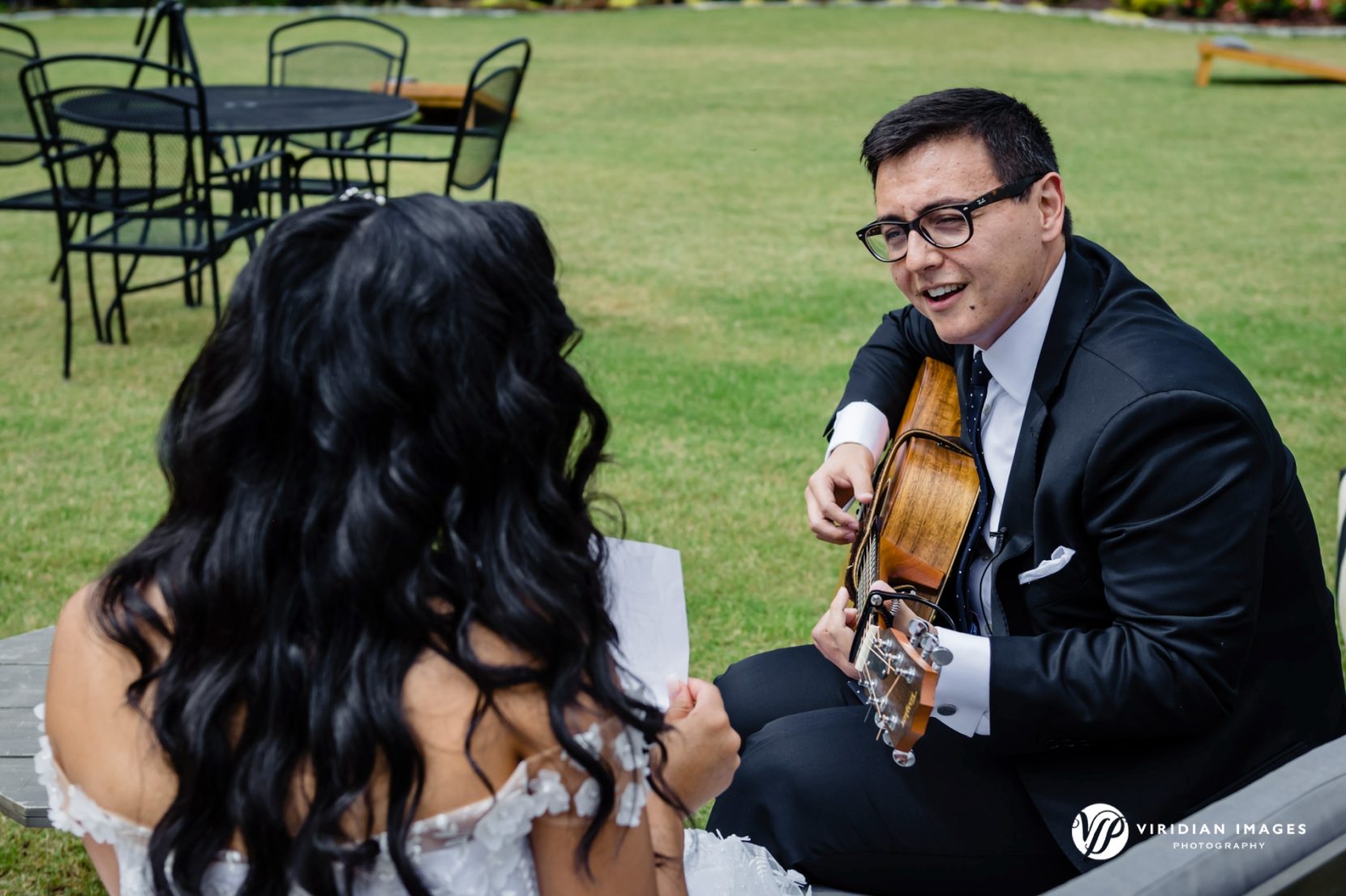 Bride becomes emotional as her groom serenades her with a surprise song during their first look