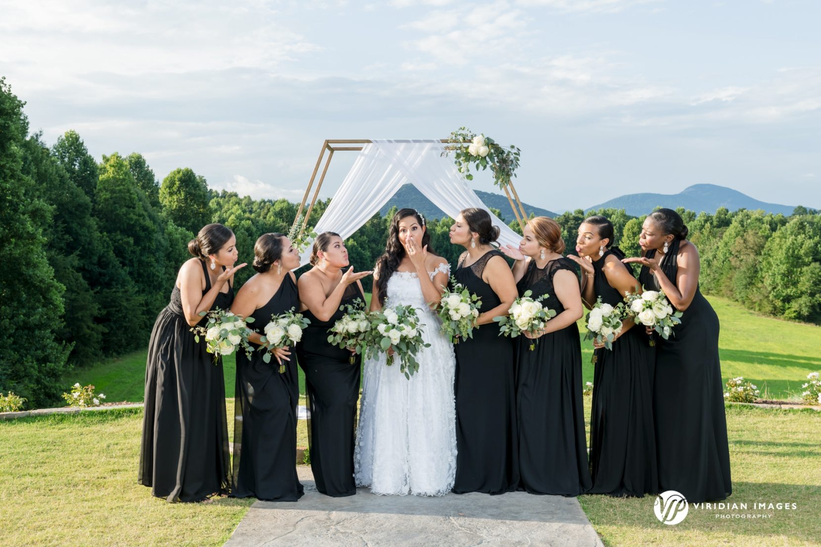 Funny portrait with bride and bridesmaids outside with mountain background