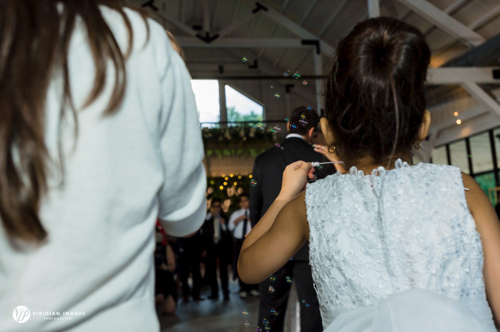 Flower girls and children blow bubbles during couple's first dance at Meadows at Mossy Creek wedding