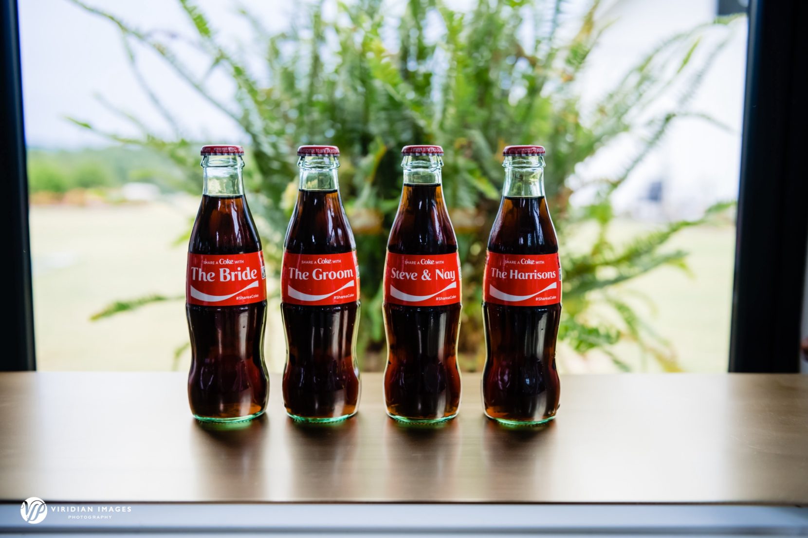 Custom coca-cola bottle lables on table in Meadows at Mossy Creek bridal suite