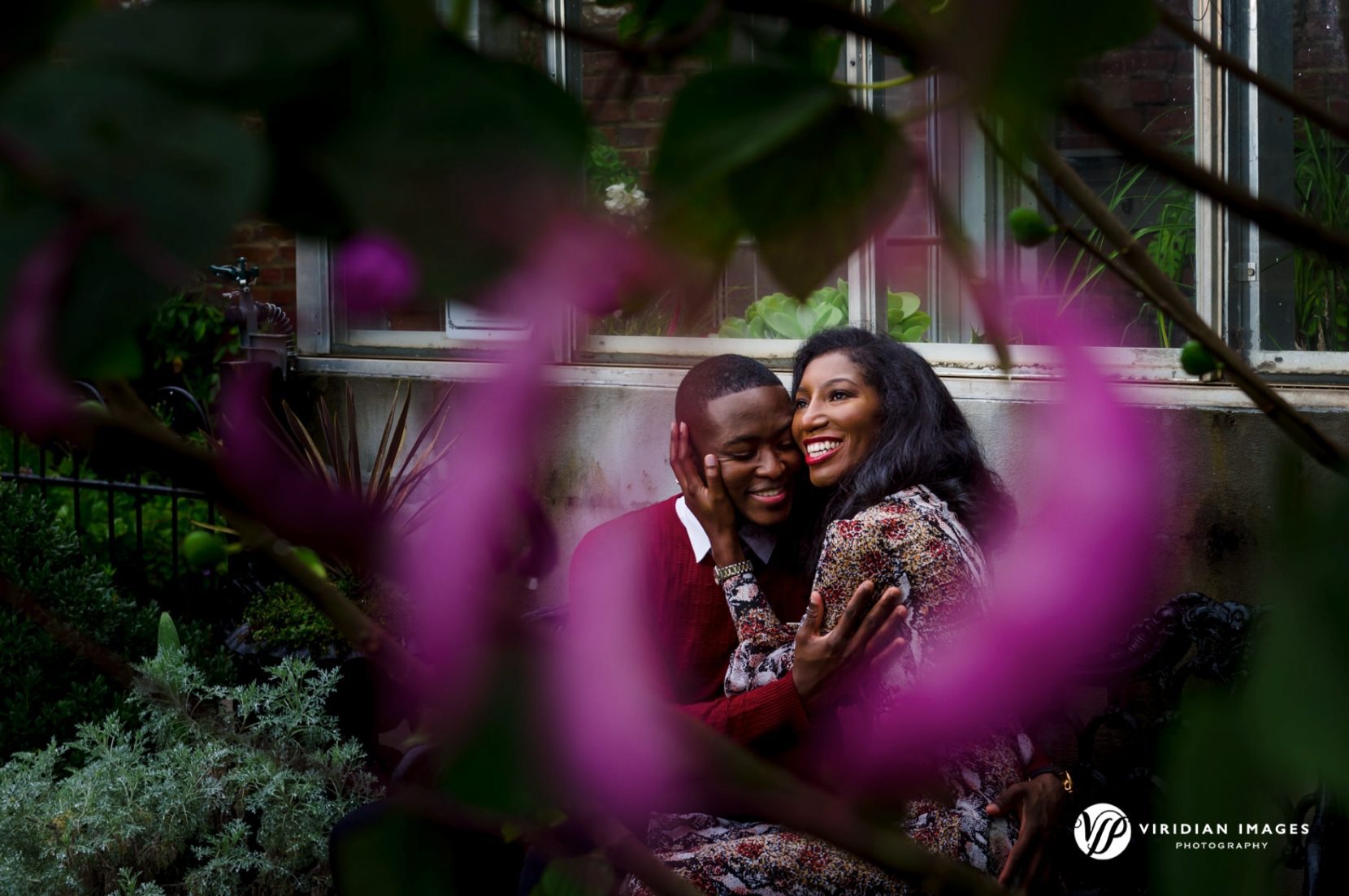 Happy engaged couple embracing during session at Oakland Cemetery