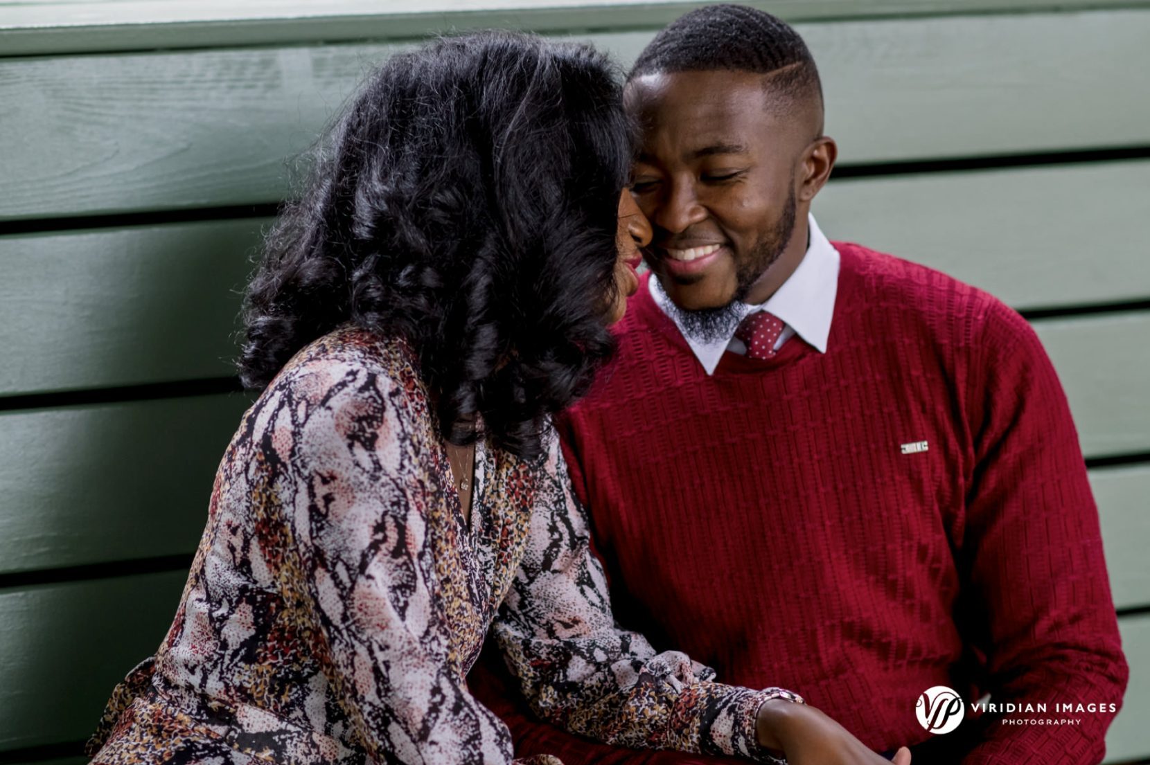 Luxury engagement photo of couple laughing together at Ponce City Market on a rainy day