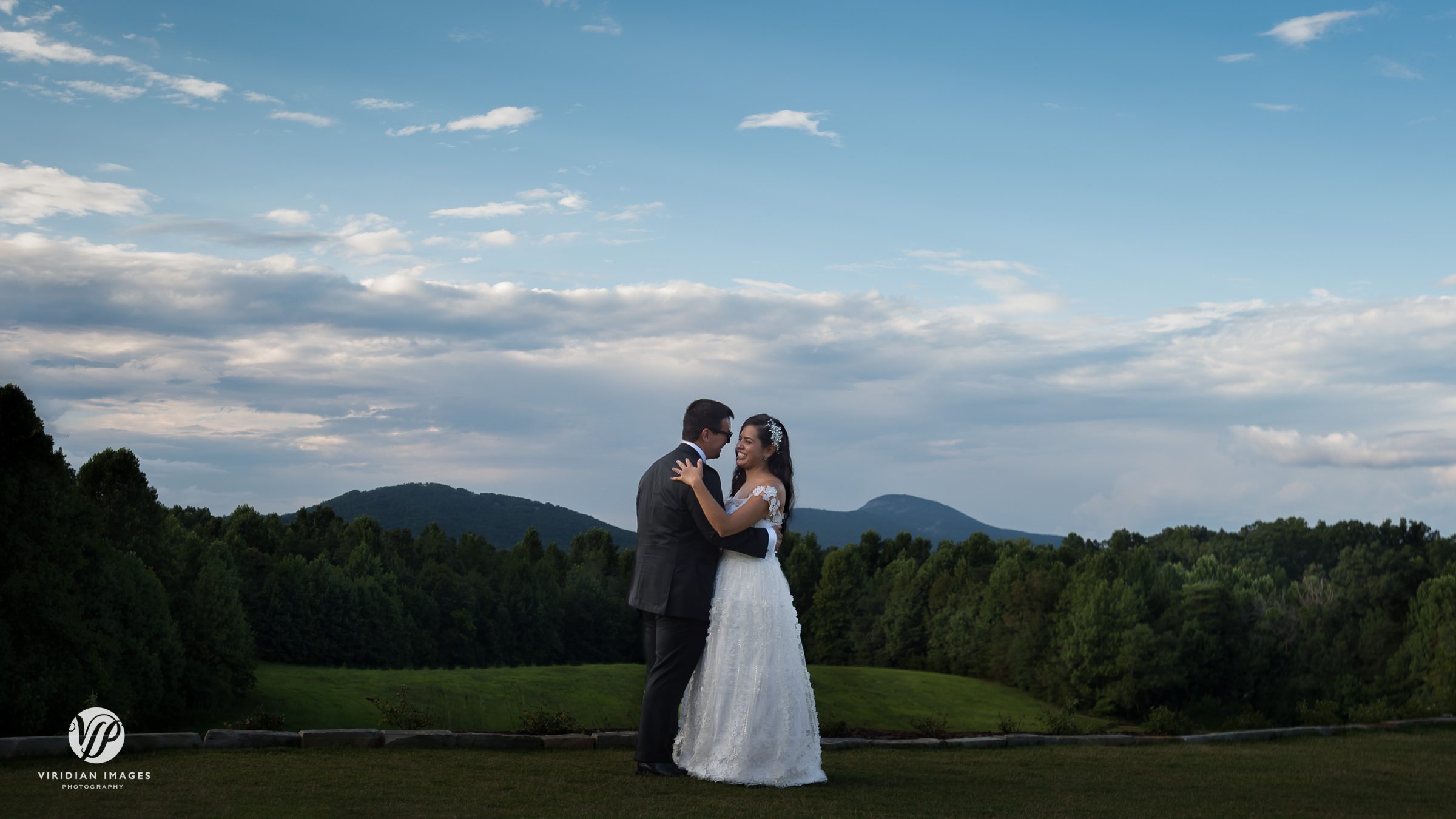 Bride and groom hugging with sweeping mountain views at Meadows at Mossy Creek