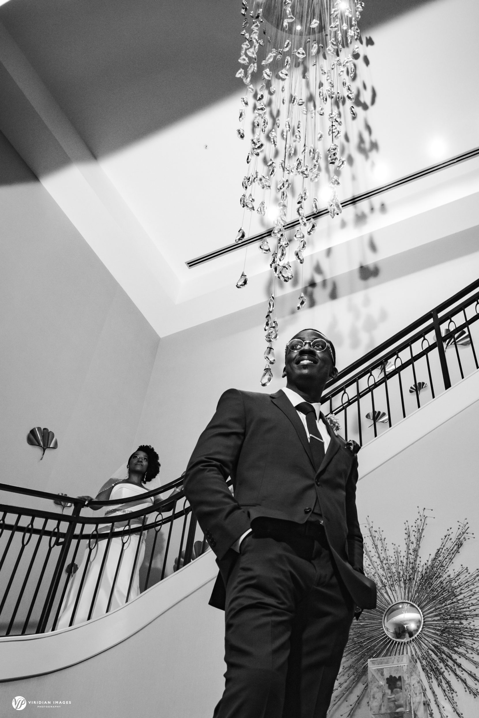 Dramatic portrait of couple at grand staircase of Hyatt Regency Atlanta