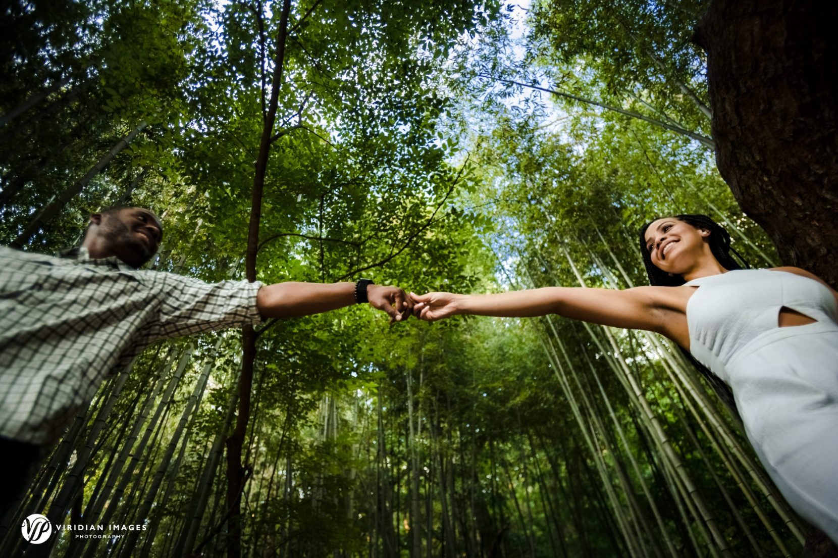 Couple reaching hand out during their walk through bamboo forest at East Palisades Trail