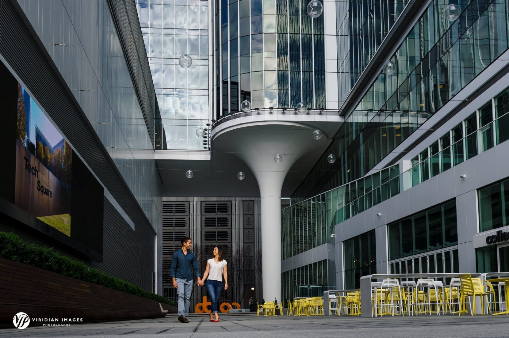 Georgia Tech couple enjoying walking through Georgia Tech's campus during their engagement session
