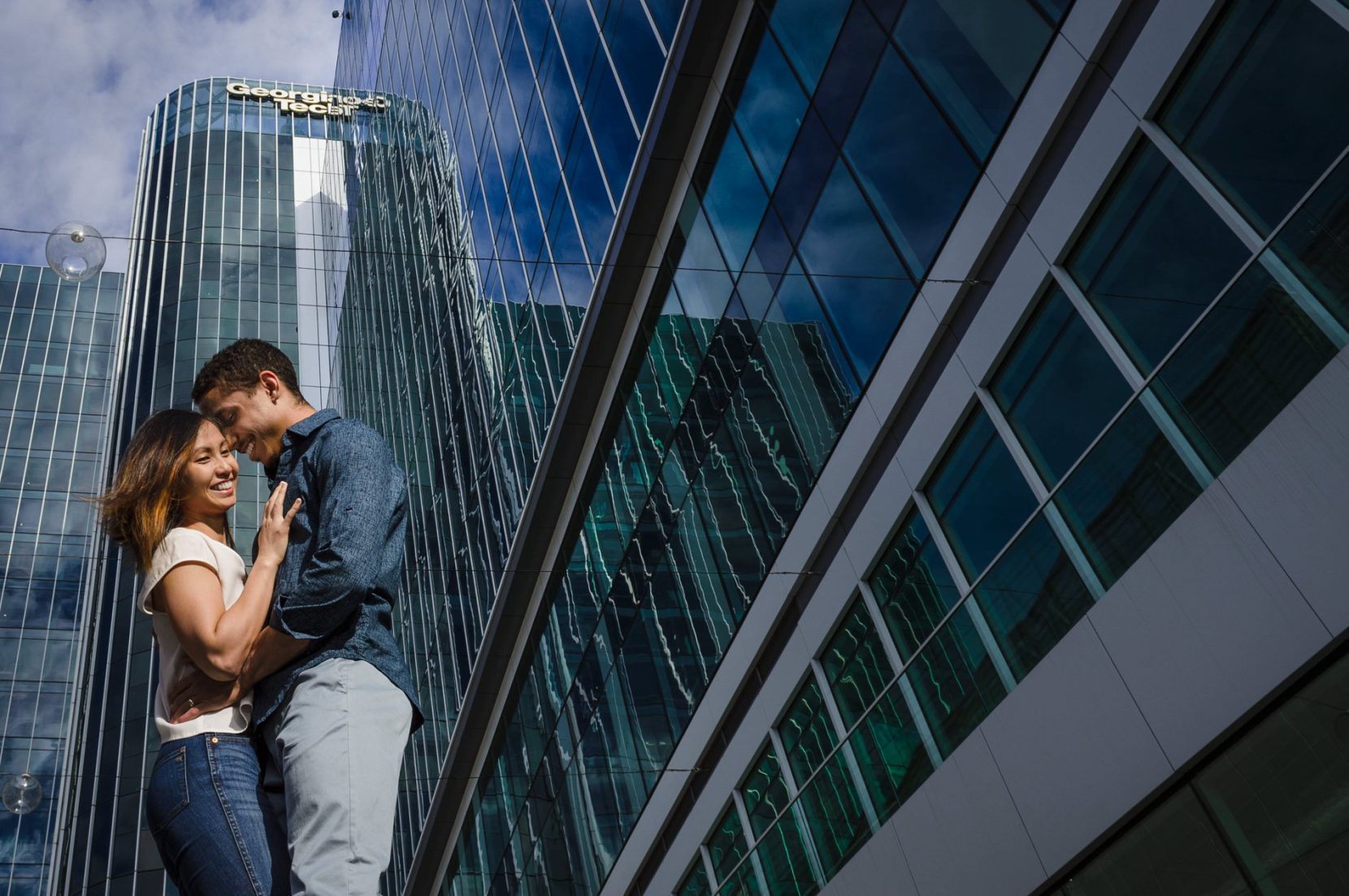Emily and Robert share a hug in front of CODA building during engagement session