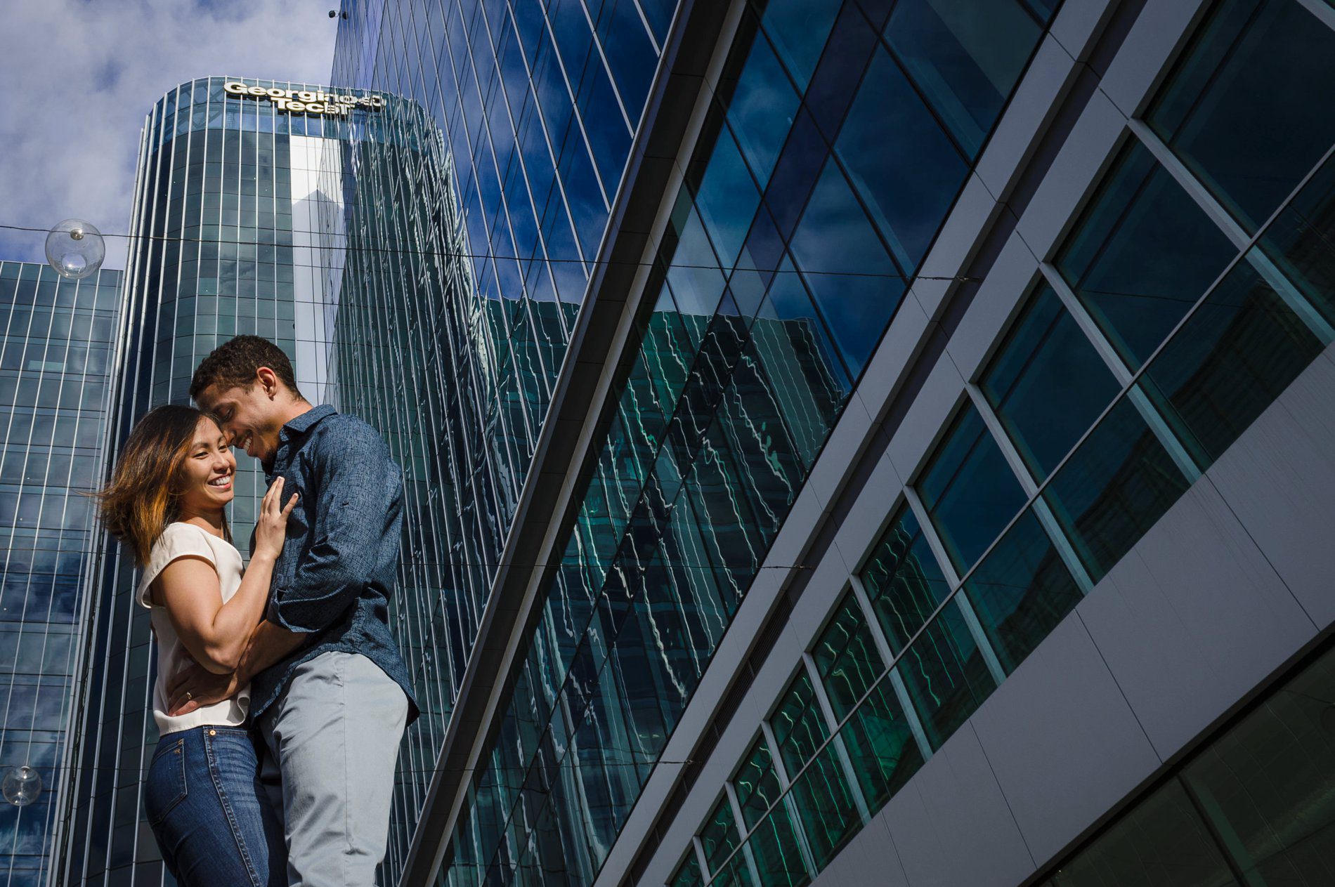 Emily and Robert share a hug in front of CODA building during engagement session