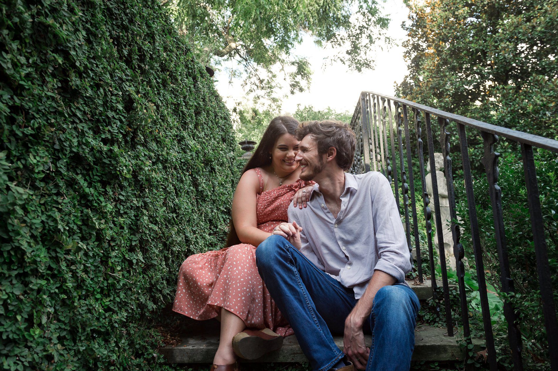 Couple enjoying themselves while sitting on steps at Founders Garden UGA
