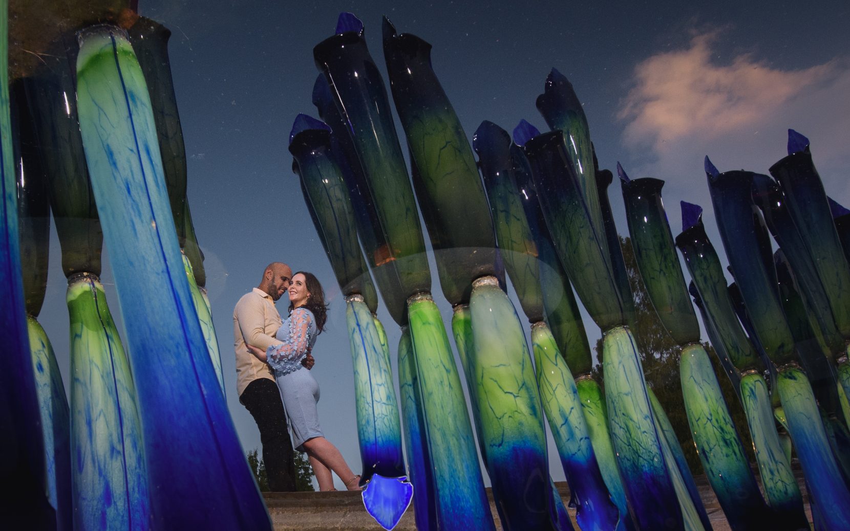 Reflection of engaged couple during chihuly exhibition at Atlanta Botanical Garden