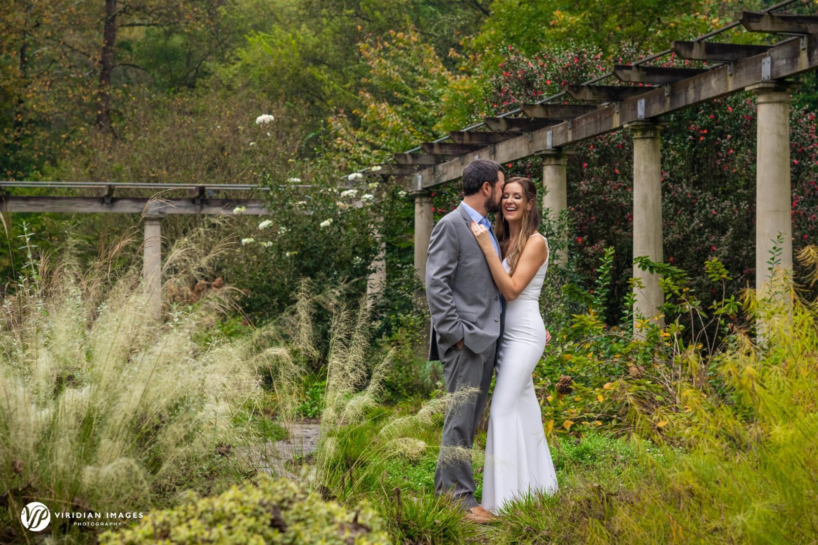 woman in white gown man in gray suit in garden setting in Atlanta
