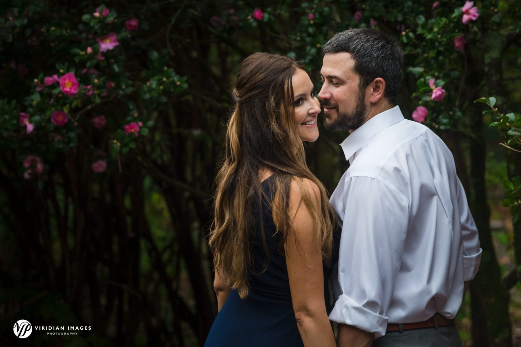 romantic photo of happy couple in front of flowering tree